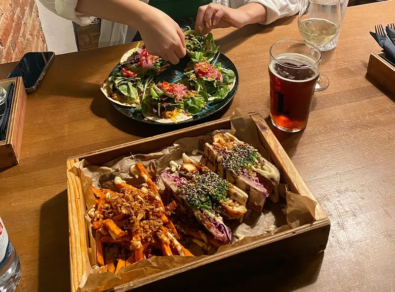 Sharing table with tuna tartar and a sando tray